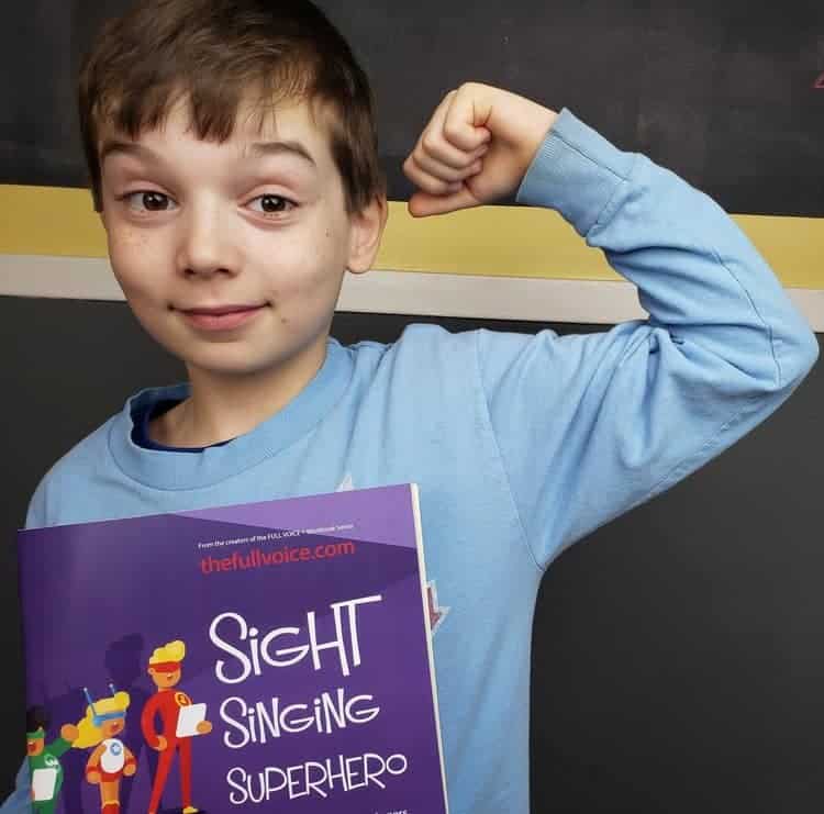 A child holding sight singing superhero